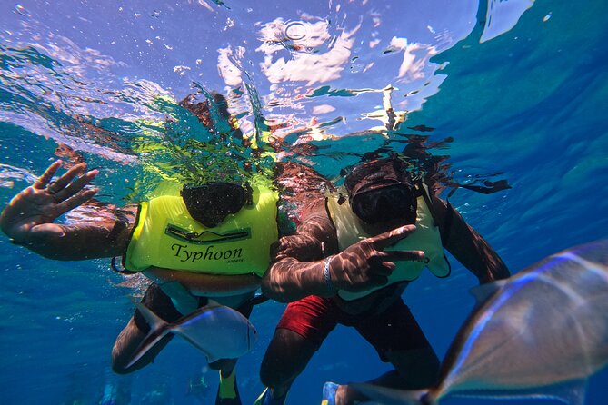 Short Excursion 4-Hour Party Catamaran and Snorkeling - A party boat with music, drinks, and a slide